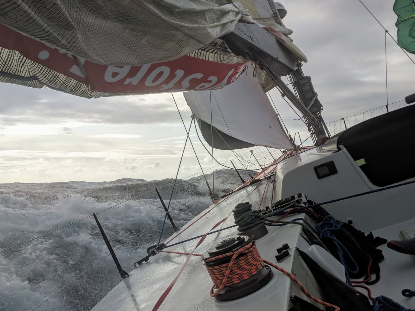 View aft from Challenger cockpit showing massive grey seas and torn sail during the storm