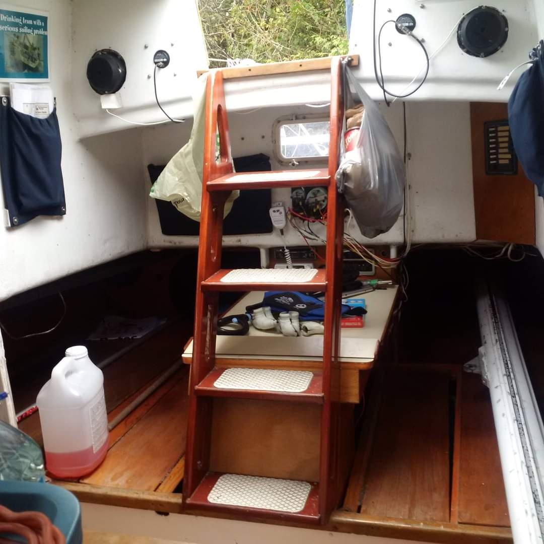Mr Jumpa interior showing companionway ladder, settee berths, and nav station area