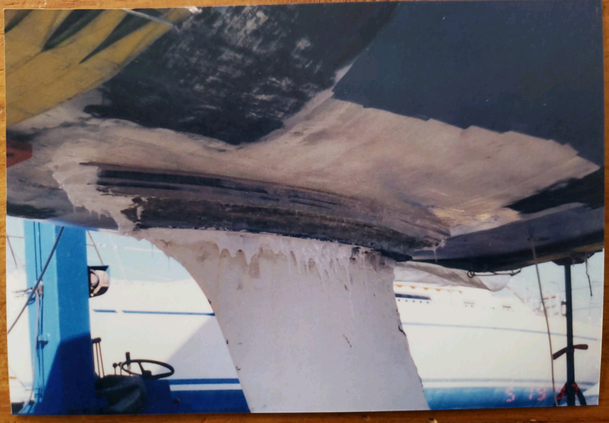 Mumm 36 keel-to-hull joint detail from below, showing the lead bulb fin keel grafted onto the cold-moulded kauri hull