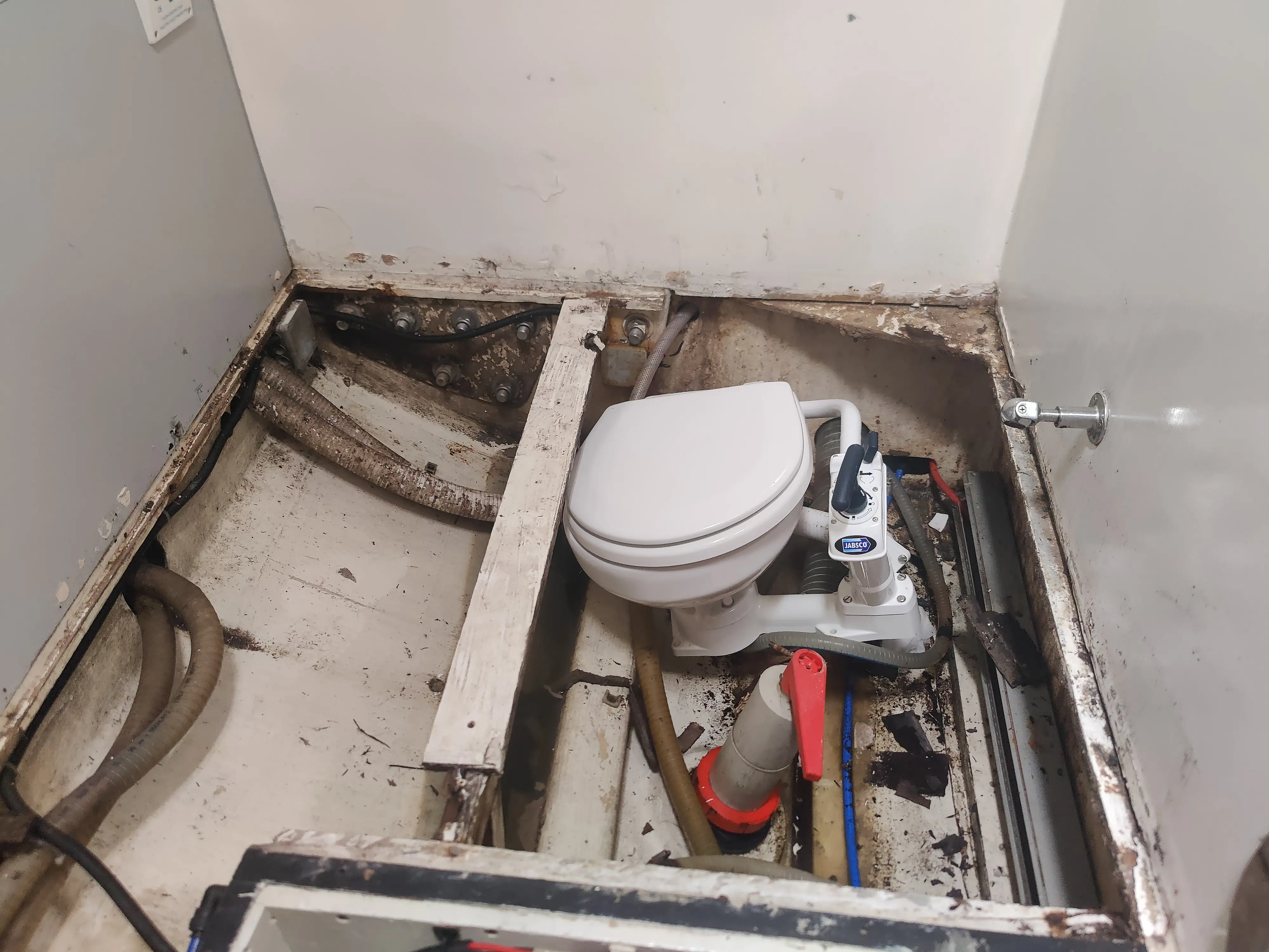 Rotted heads floor — exposed bare hull