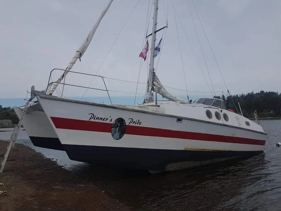 Port side of catamaran after careening and antifoul application, repairs complete